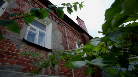 Russian town. Pan of an old two-storeyed residential house from red brick. HD Stock Footage 68664224