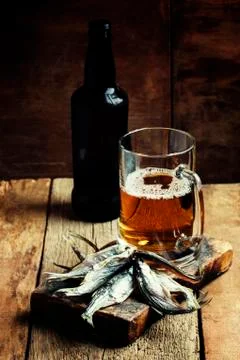 Russian tradition: dried roach and beer on vintage wooden background, selecti Stock Photos
