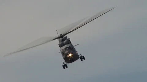 Russian transport gray helicopter Mi-26 performs left turn with climb Stock Footage 107584574