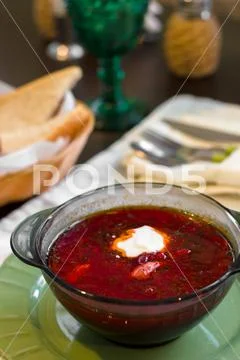 Russian ukrainian soup borscht with greens and sour cream. Beetroot soup in b Stock Photos