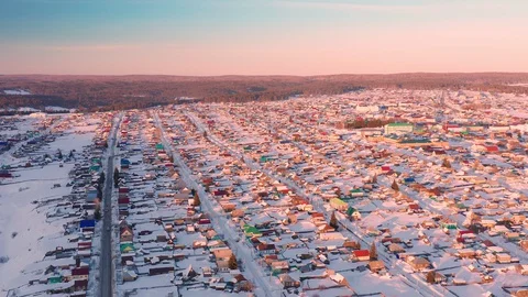 Russian village among the forest and hills on a winter sunset evening. Stock Footage 127784553