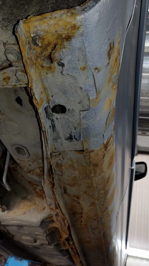 Rust and bubbling paint on a silver car rocker panel Stock Footage 334321622