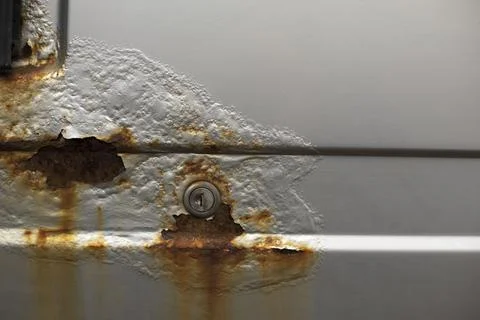 Rust on the car. Surface with damaged paint. Corrosion on metal. Stock Photos