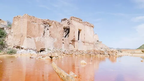 Rust-Colored Toxic Water Pool Reflecting Crumbling Industrial Ruins Stock Footage 308662606