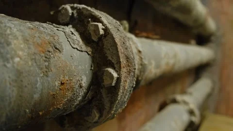 Rust-covered pipes with severe corrosion and flaking layers, highlighting Stock Footage 295779562