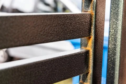 Rust forming on non galvanized epoxy painted steel metal gate Stock Photos