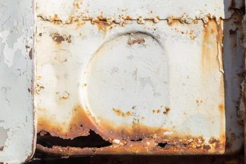 Rust.A fragment of an old rusty car with holes and cracks. Stock Photos