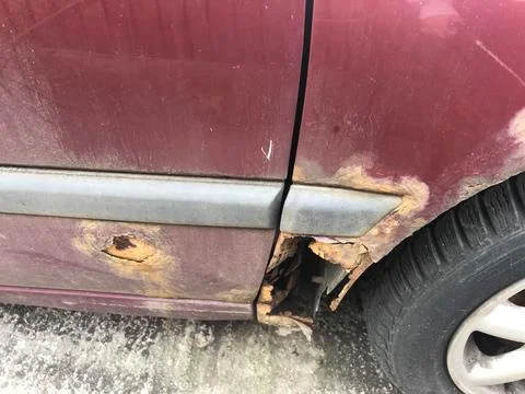 The rust made a hole in the car. Stock Photos