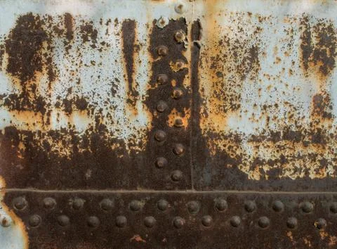 Rust metal texture with rivets, abstract grunge background Foto stock