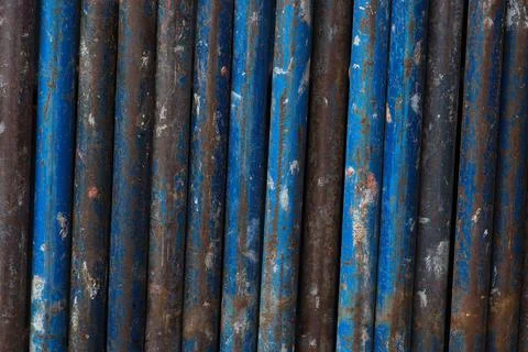 Rust metal vertical lines background blue tubes scaffold industrial iron text Stock Photos