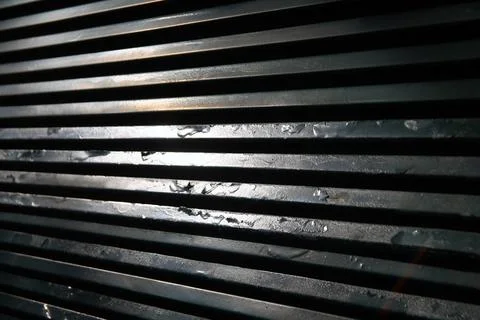 The rust of a old metallic grid with the reflections of the sun Stock Photos