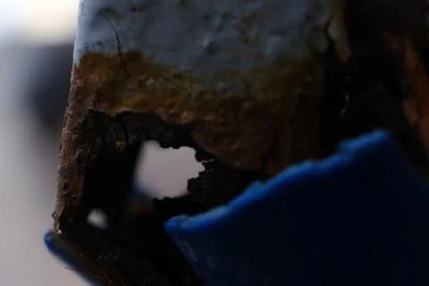 Rust on a piece of metal with broken plastic blue rubber Stock Photos