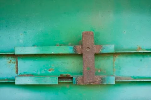 Rust plate on the engineering case painted in green Stock Photos