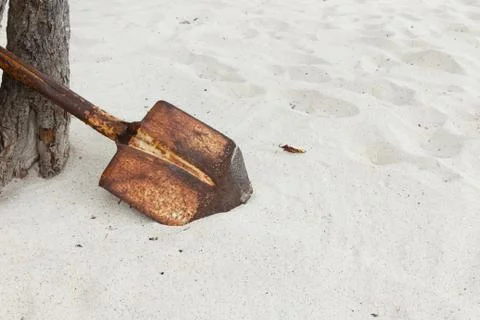 Rust shovel on the beach summer time Stock Photos