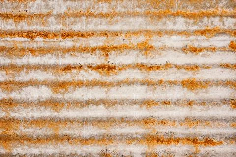 Rust-stained corrugated metal panel featuring worn, ridged surface Stock Photos