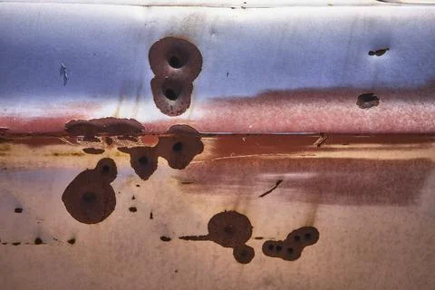 Rust Texture and Bullet Holes on Abandoned Vehicle Metal Surface Stock Photos