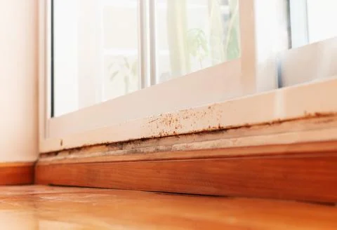 Rust on the window frame with moisture on the wall at floor level Fotos Stock