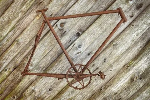 Rusted bicycle frame hanging on a wall Stock Photos