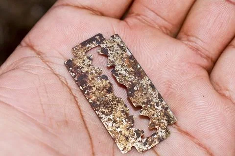 A rusted blade lying in the soil Stock Photos
