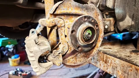 Rusted car brake disc and caliper showing corrosion and needed replacement Stockbeeldmateriaal 332684875