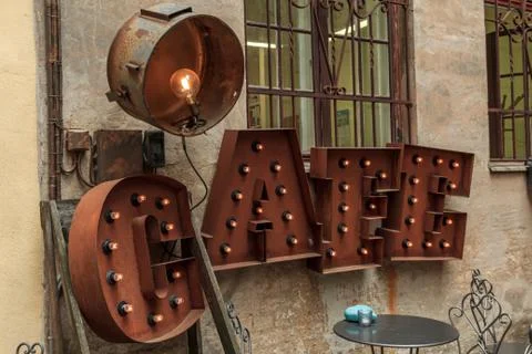 Rusted color word cafe with lights Stock Photos