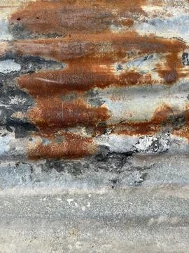 Rusted corrugated metal texture with orange oxidation and weathered zinc surface Stock Photos