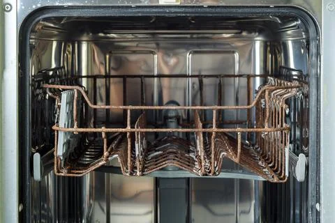 Rusted dish rack inside an old dishwasher, showing severe corrosion and wea.. Foto stock