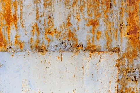 Rusted flat sheet metal surface with leftovers of white and light blue paint Stock Photos