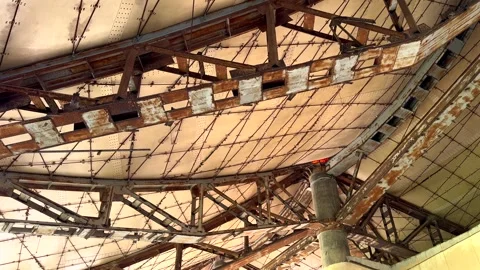 Rusted framework forms intricate grid pattern in abandoned desert structure Stock Footage 287296112