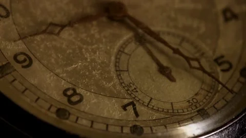 Rusted hands move steadily over a textured watch dial Video stock 329595877