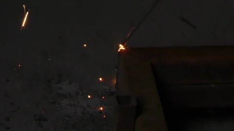 The rusted iron bars are being joined using welding machine and arc Stock Footage 112854970