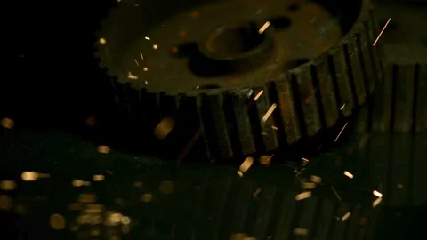 Rusted mechanical gears hitting surface with bright glowing sparks Stock Footage 327580208