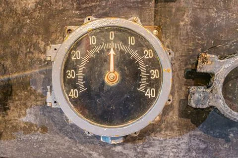 Rusted metal compass on aged surface, possible industrial background, natural Stock Photos