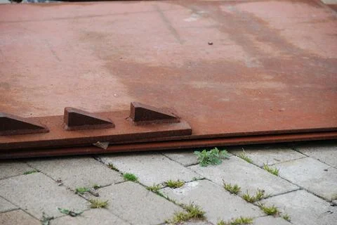 Rusted Metal Sheets on Stone Pavement Stock Photos