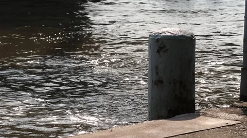 Rusted mooring post and floating concrete dock. Beautiful and peaceful river. Stock Footage 99720723