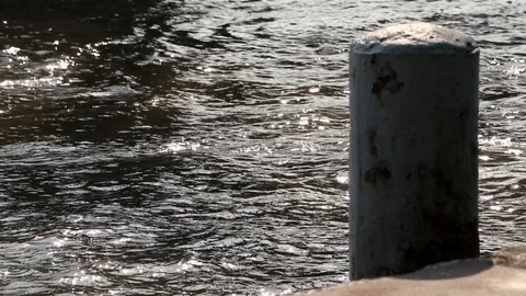 Rusted mooring post and floating concrete dock. Beautiful and peaceful river. Stock Footage 99720964