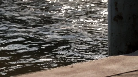 Rusted mooring post and floating concrete dock. Beautiful and peaceful river. Stock Footage 99721164