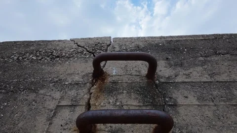 Rusted mooring ring on cracked concrete dock close up harbor detail Stock Footage 337458459