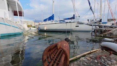 Rusted mooring ring with rope and yachts in marina background close up Stock Footage 337458763