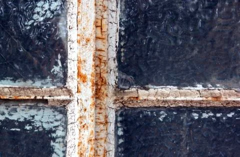 Rusted neglected window frame with flaking putty Stock Photos