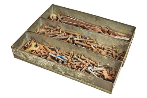 Rusted nuts and bolts in a box isolated on white background Photos