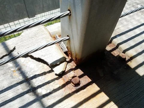 Rusted nuts and broken cement in parking garage Stock Photos
