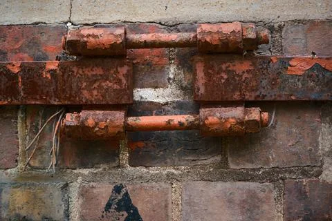 Rusted old bands secure integrity of tall brick smoke stack Stock Photos