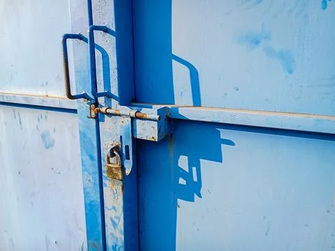 Rusted Padlock Locking Blue Painted Iron Door Close Up Stock Photos