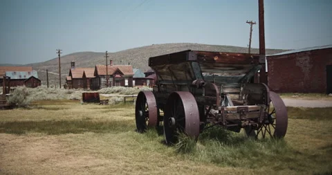 Rusted pioneer wagon in the gold mining town of Bodie California Stock Footage