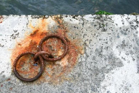 Rusted Q Shaped Iron Ring on Stone for Boats or Ships Stock Photos