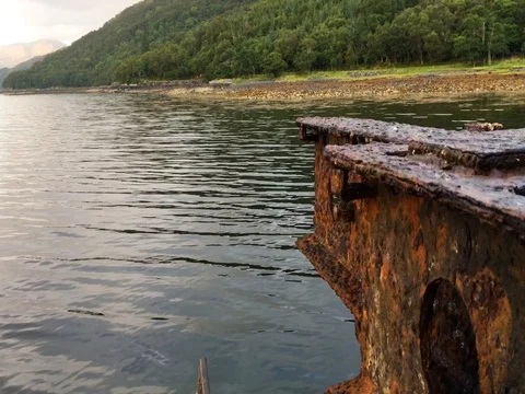 The Rusted Remains of a dock jut out into the open waters of a Scottish Loch 動画素材 79884904
