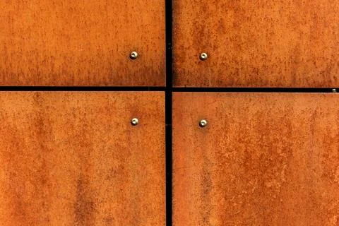 Rusted steel plates cladding texture, orange rust metal background with joints Фото
