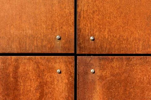 Rusted steel plates cladding texture, orange rust metal background with joints Stock-Fotos