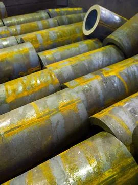 Rusted thick steel pipe chunks after sawing waiting for machining operations Stock Photos